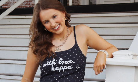 Woman wearing a black polka dot Kappa tank top