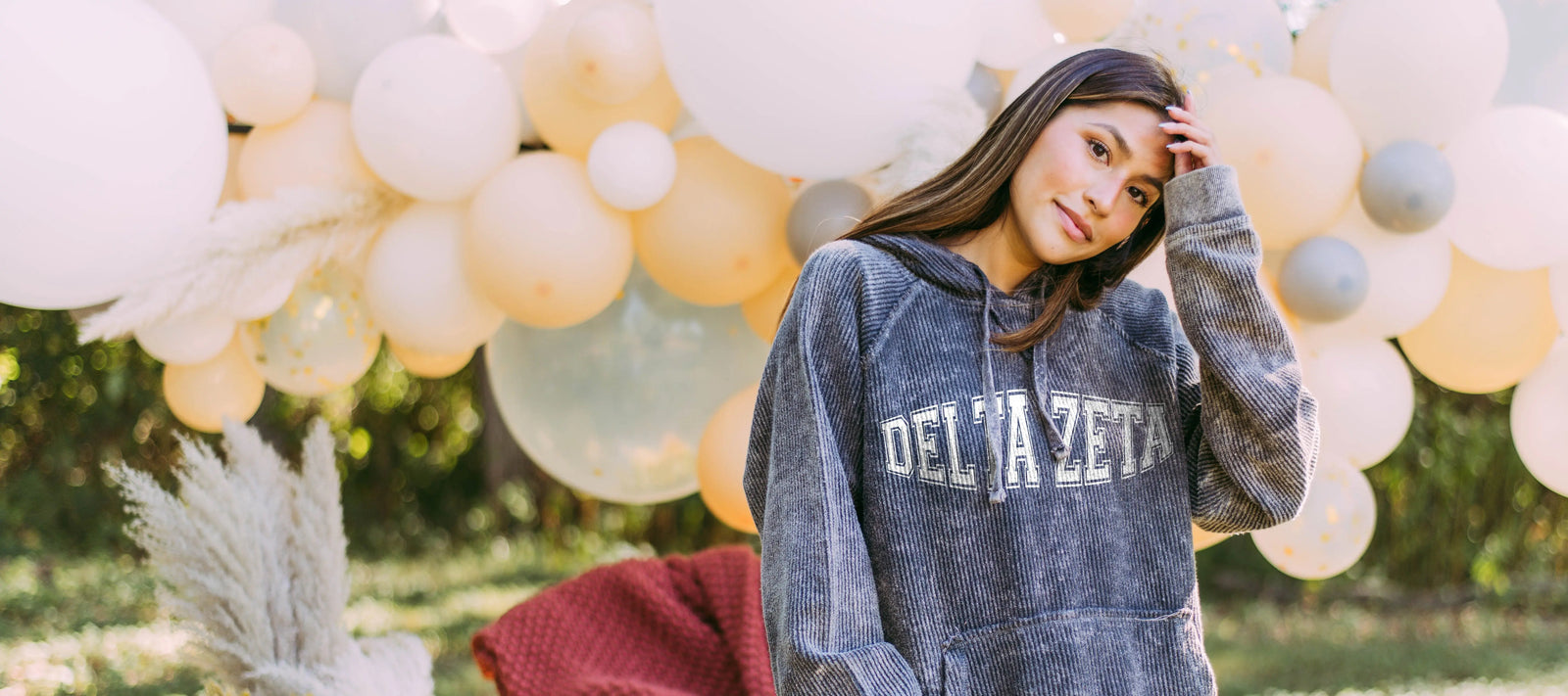 Girl wears a DZ charcoal corduroy hoodie