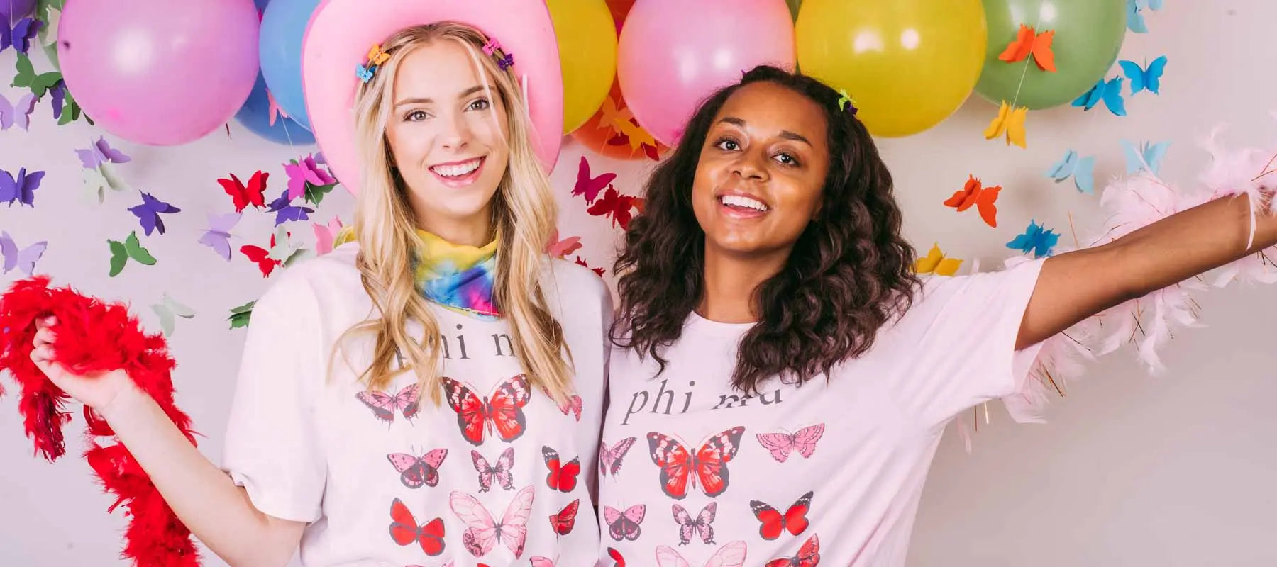 Two girls wear pink Phi Mu butterfly tshirts