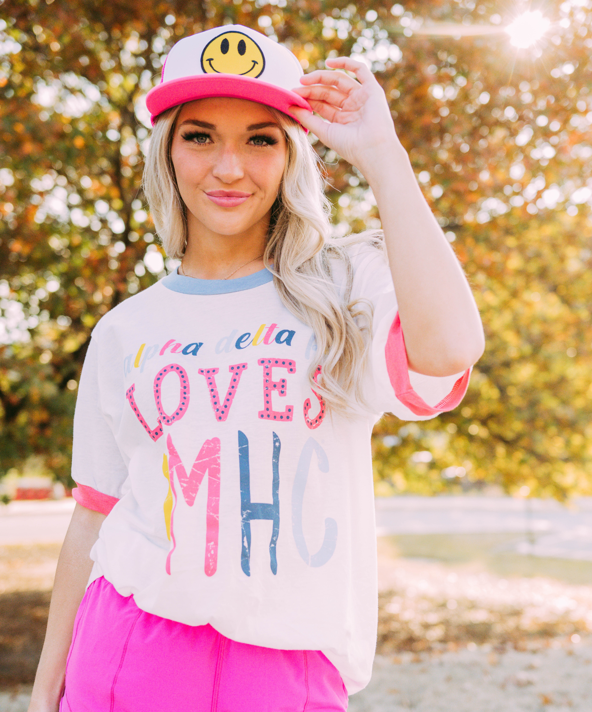 A girl wears a white color block ringer that reads, 