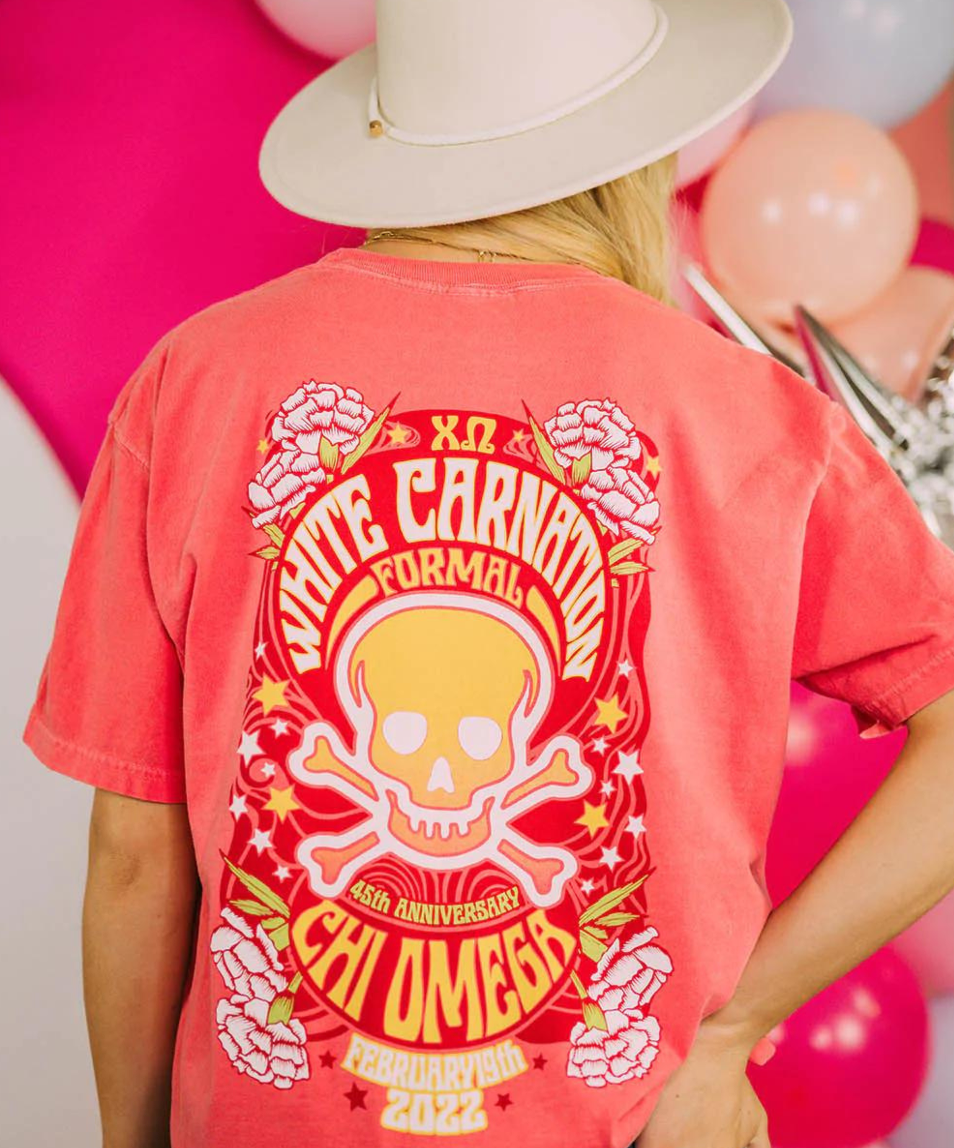 Girl's back faces the camera wearing a red shirt that reads, 