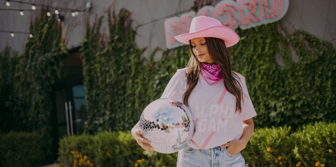 Girl wears a pink Alpha Gam tshirt