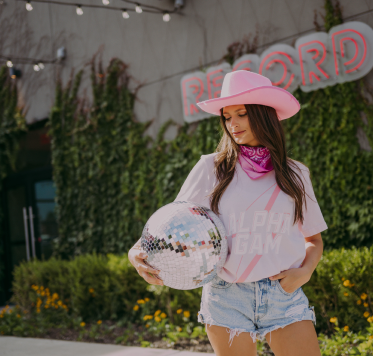 Girl wears a pink Alpha Gam tshirt