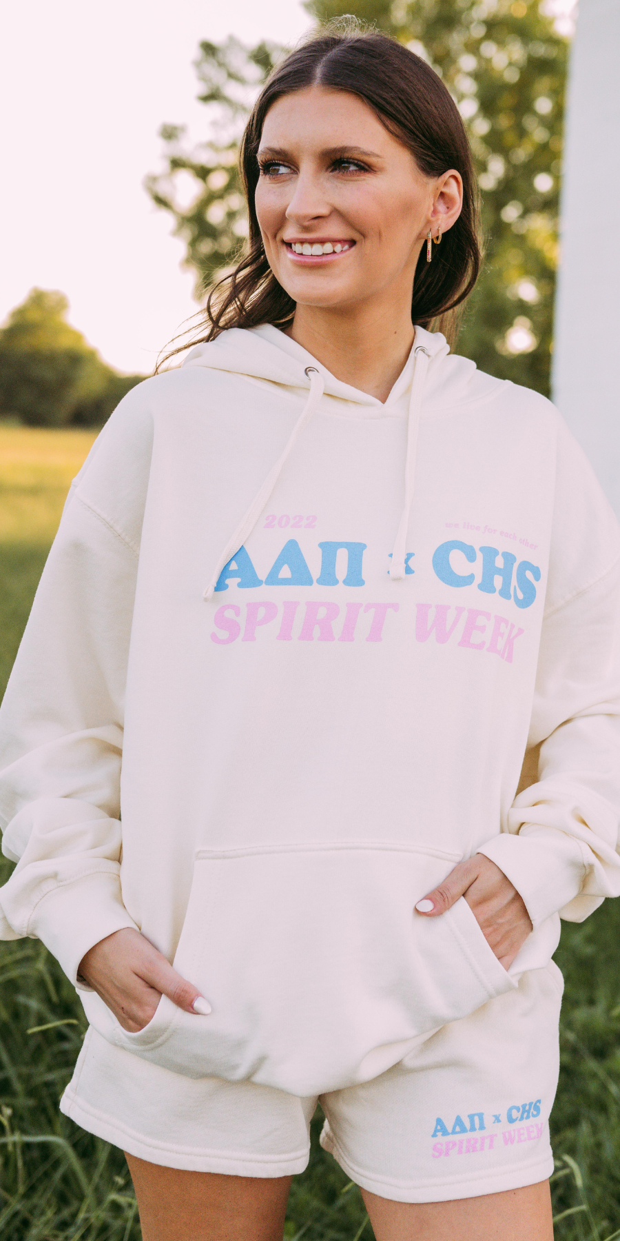 Girl wearing cream hoodie with ADPi letters and "CHS Spirit Week" written across it