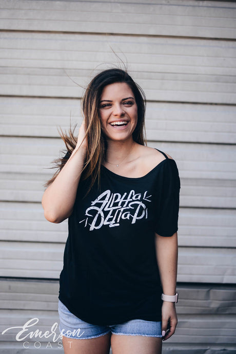 Girl wears black shirt that reads Alpha Delta Pi in white.