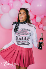 Girl wears white long sleeve that reads "Diners, Drive-ins, and Diamonds. ADPi Bid Day."