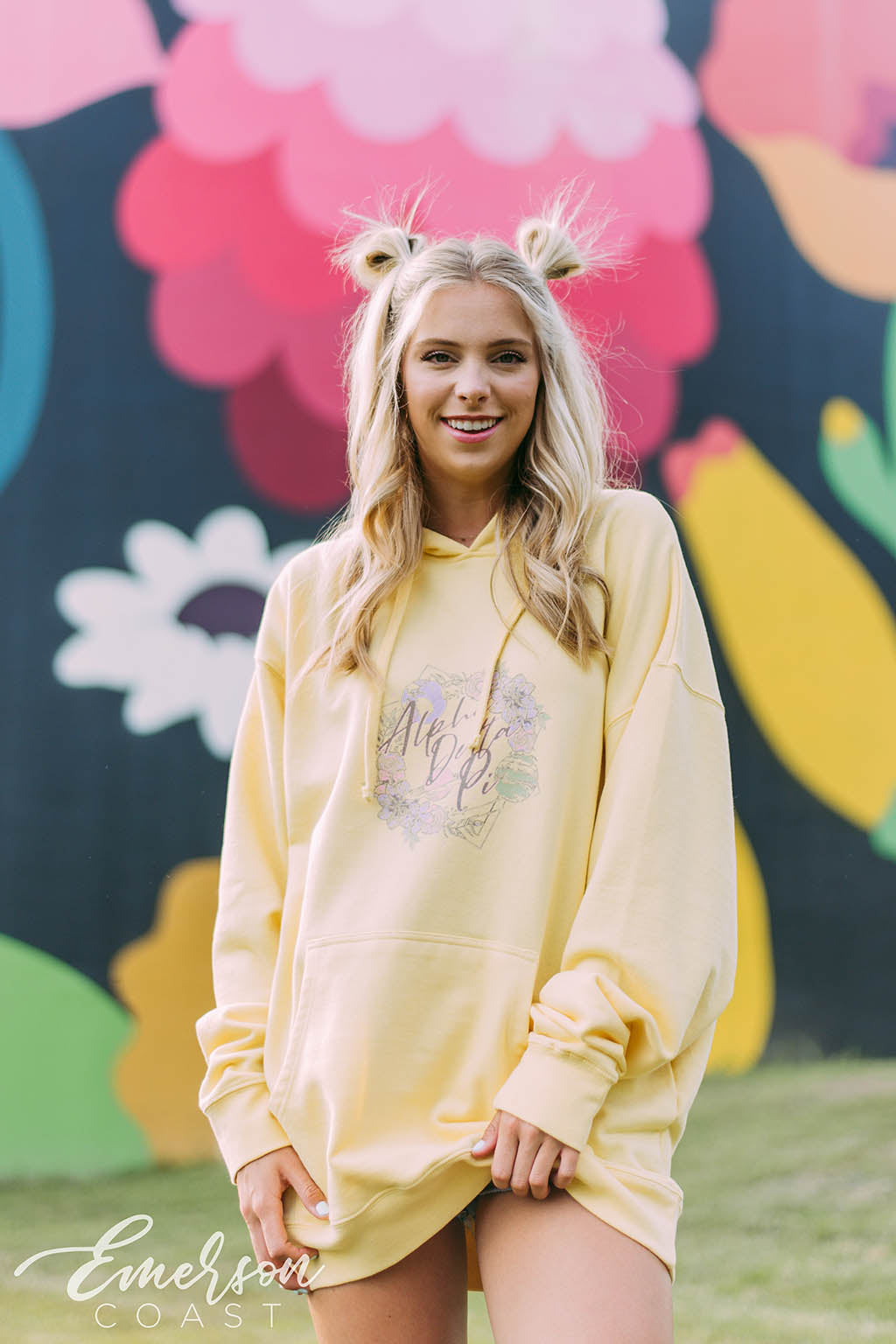 Girl wears a yellow hoodie that reads Alpha Delta Pi.
