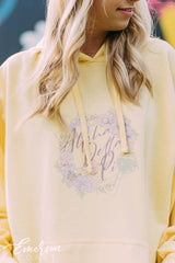 Girl wears a yellow hoodie that reads Alpha Delta Pi.