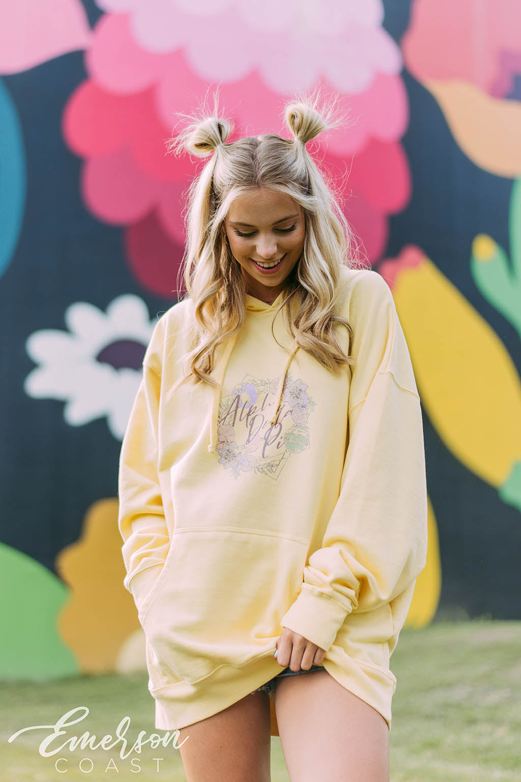 Girl wears a yellow hoodie that reads Alpha Delta Pi.