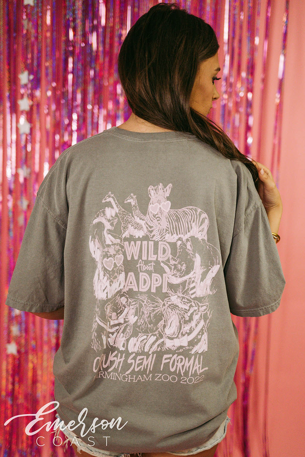 Girl wears green tshirt that reads "Wild About ADPi" and features an illustration of safari animals.