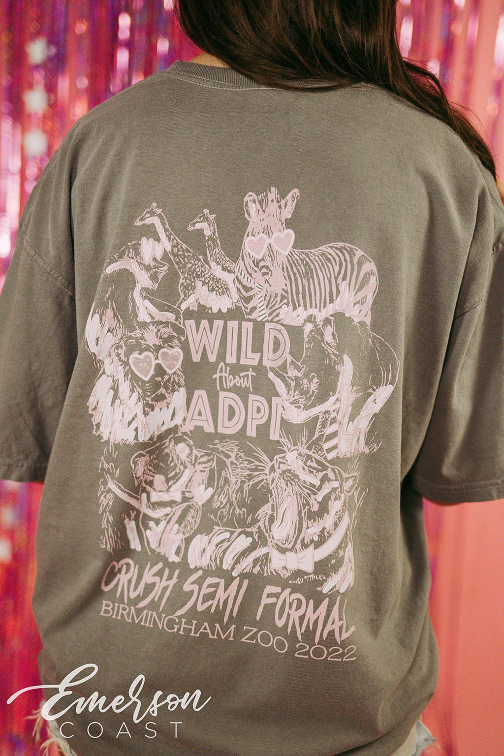 Girl wears green tshirt that reads "Wild About ADPi" and features an illustration of safari animals.