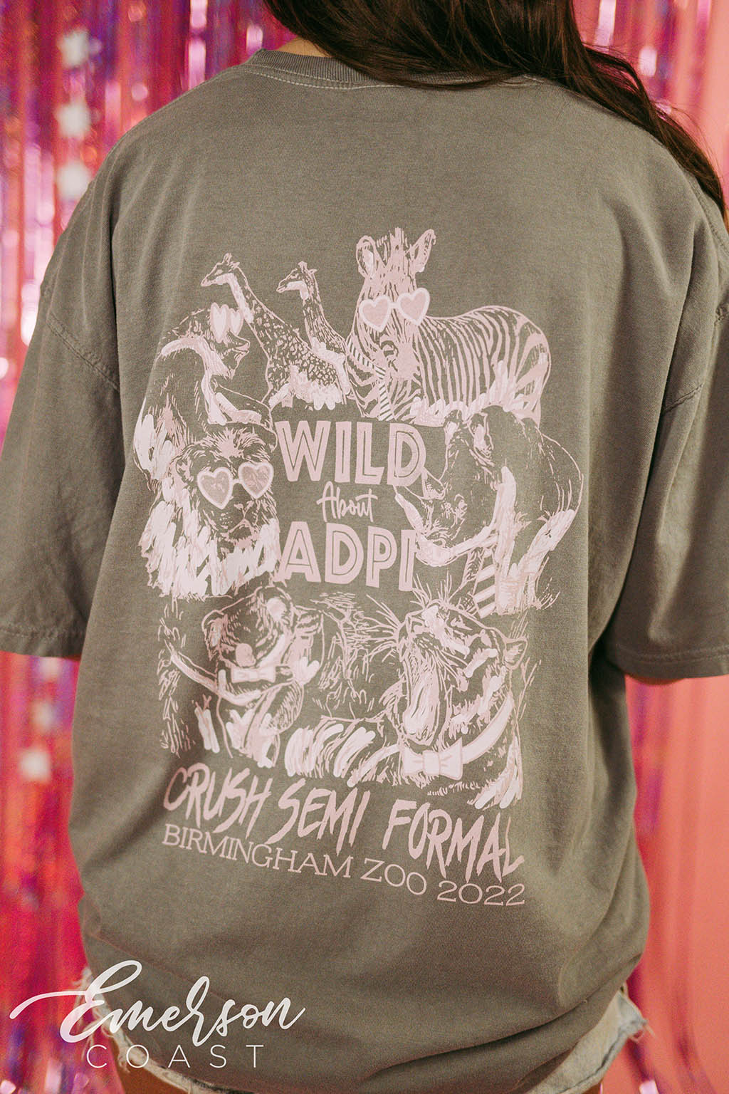 Girl wears green tshirt that reads "Wild About ADPi" and features an illustration of safari animals.