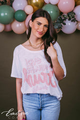 Girl wears white "Love Shouldn't Hurt" Alpha Chi shirt