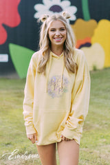 Girl wears a yellow hoodie that reads Alpha Delta Pi.
