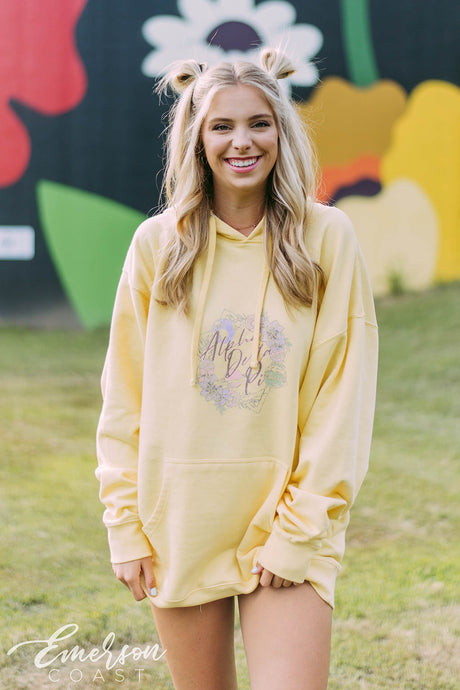 Girl wears a yellow hoodie that reads Alpha Delta Pi.