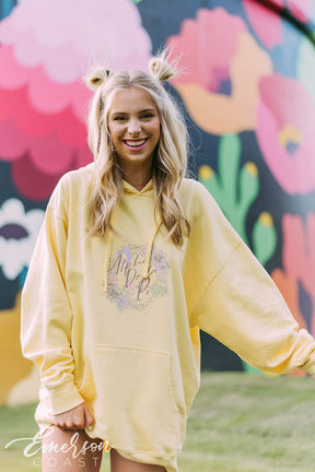 Girl wears a yellow hoodie that reads Alpha Delta Pi.