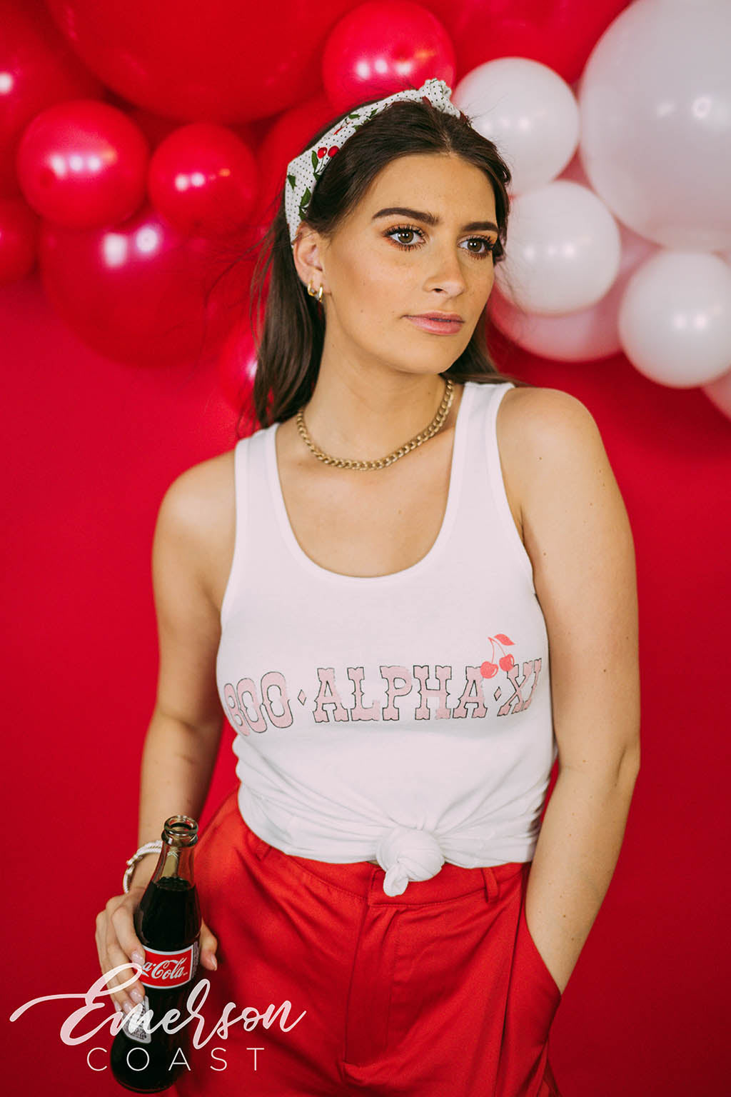 Girl wears white tank with 1-800-Alpha-Xi written across it.