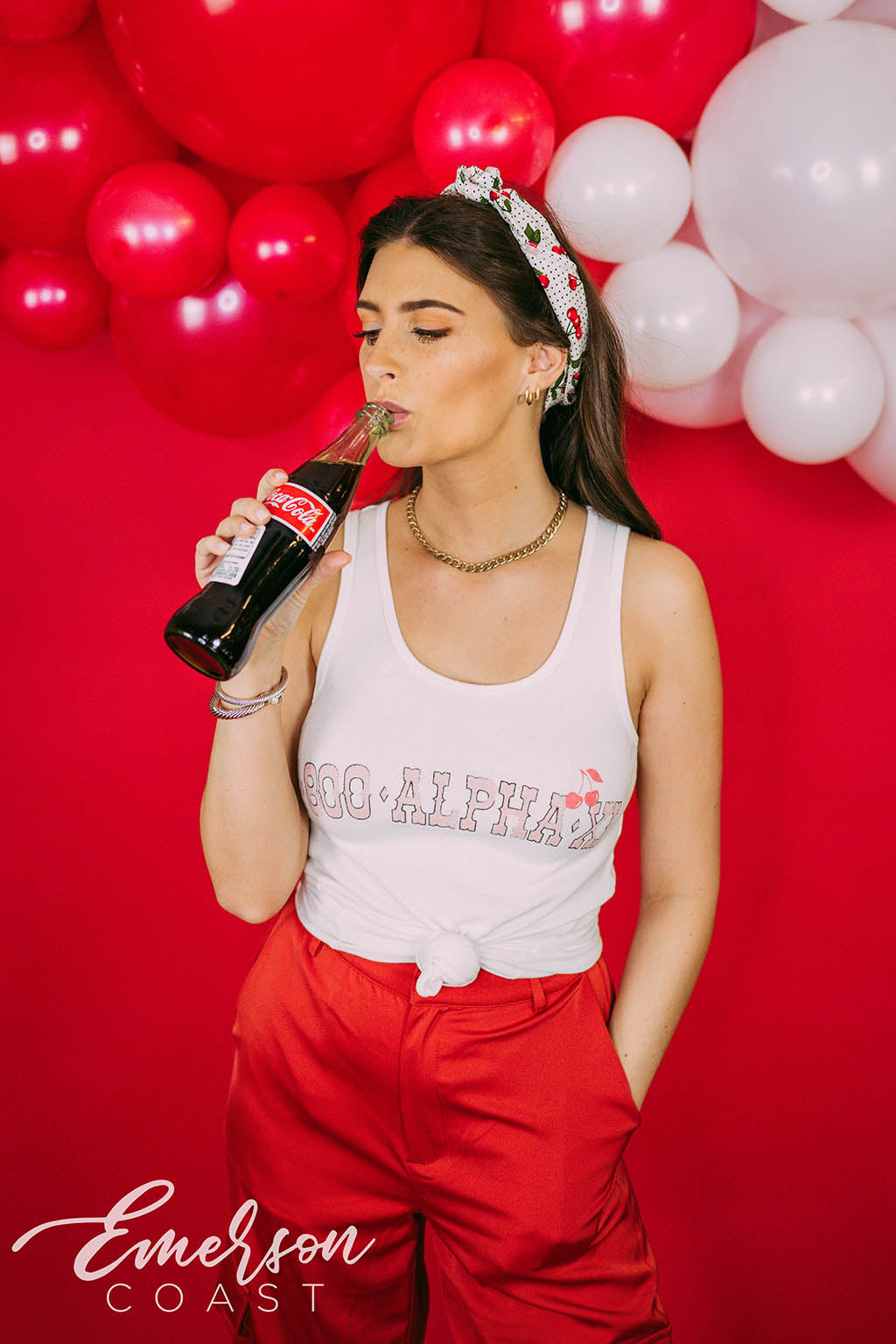 Girl wears white tank with 1-800-Alpha-Xi written across it.