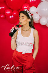 Girl wears white tank with 1-800-Alpha-Xi written across it.