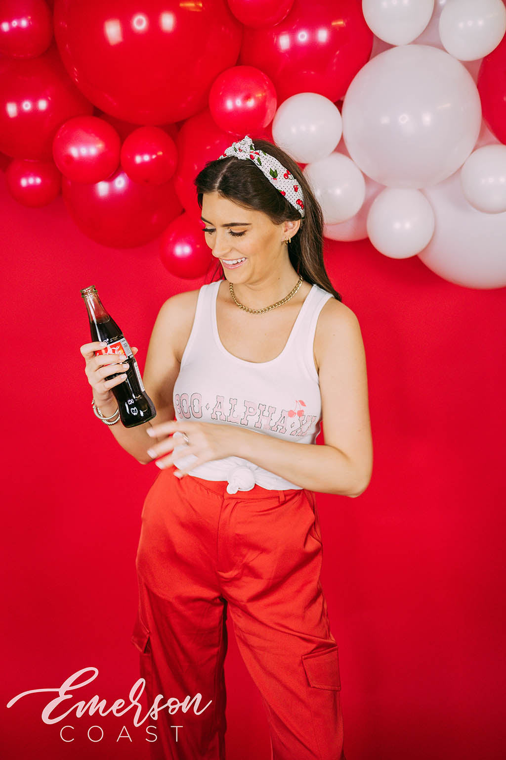 Girl wears white tank with 1-800-Alpha-Xi written across it.