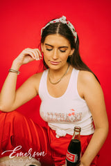 Girl wears white tank with 1-800-Alpha-Xi written across it.