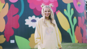 Girl wears an array of pastel hoodies.